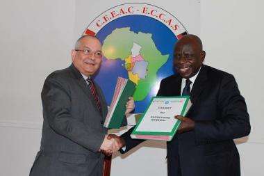 © 2015 AU-IBAR. Mr. Ahmad ALLAM-MI, General Secretary of ECCAS (at left) and Mr. Emile Essema, Executive Secretary of COREP(at right), exchanging of the signed documents and mutual congratulations.